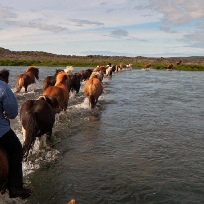 Experienced riders crossing a river